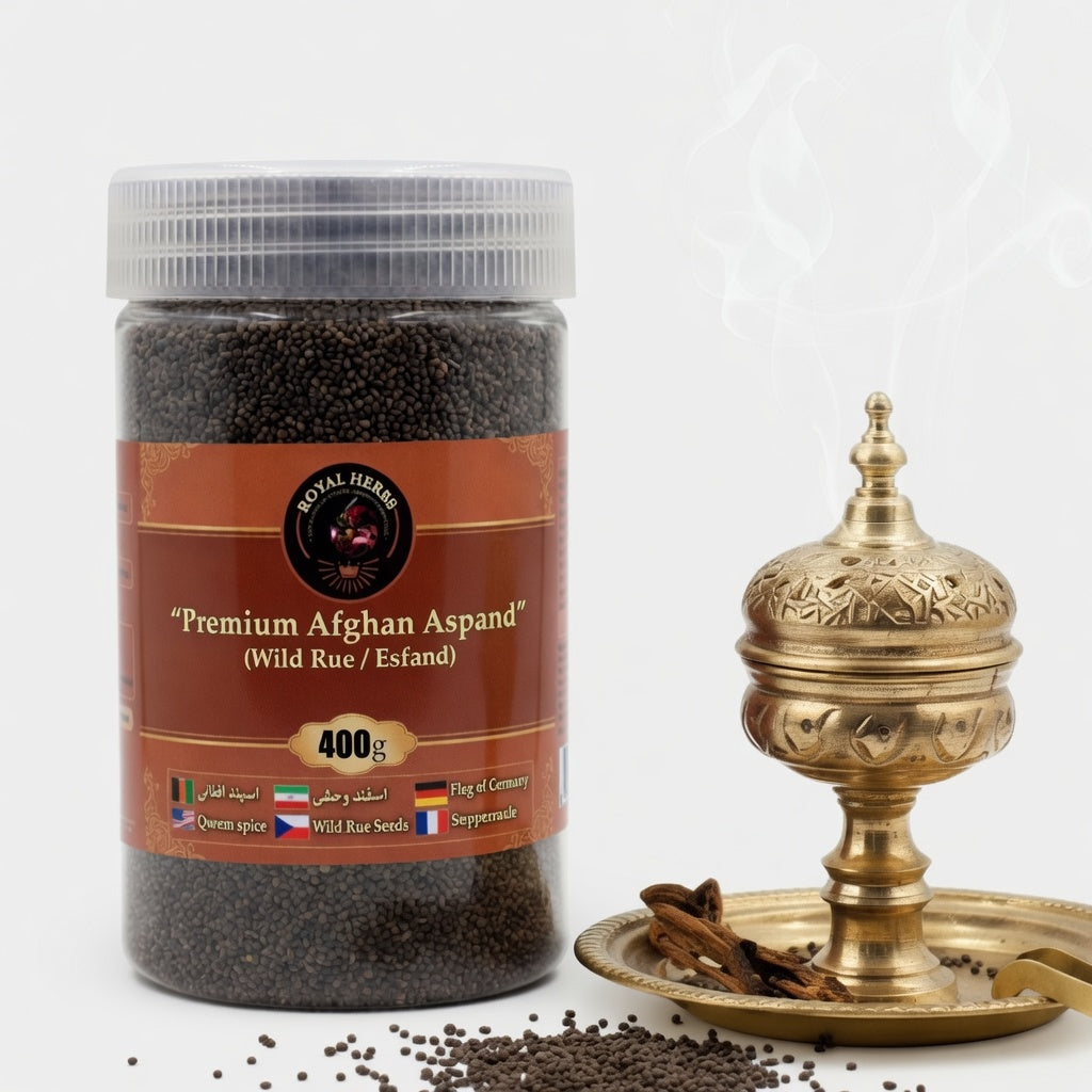 A clear plastic jar filled with dark wild rue seeds (Aspand/Esfand), labeled "Premium Afghan Aspand (Wild Rue / Esfand) 400g" by Royal Herbs, placed next to an ornate brass incense burner with white smoke rising. Some seeds are scattered in the foreground on a clean white background.