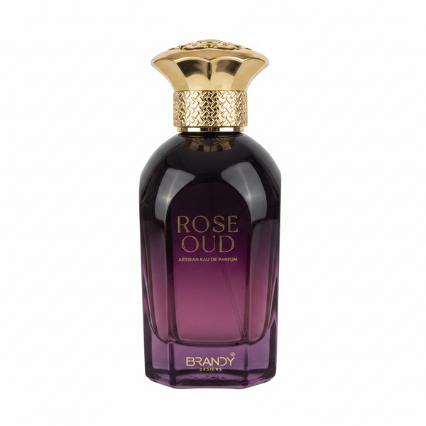 Two bottles of 'Rose Oud' Brandy perfume and its packaging on a stone surface.