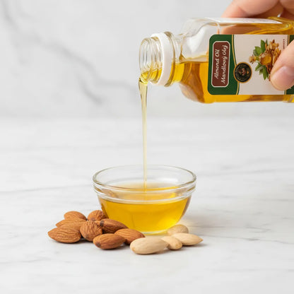 Pure Afghan Almond Oil poured into bowl – light golden cold-pressed sweet almond oil 100ml

