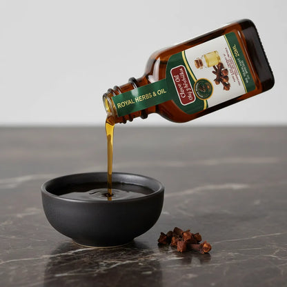 Pure Afghan Clove Oil poured into bowl – deep amber steam-distilled clove essential oil 30ml
