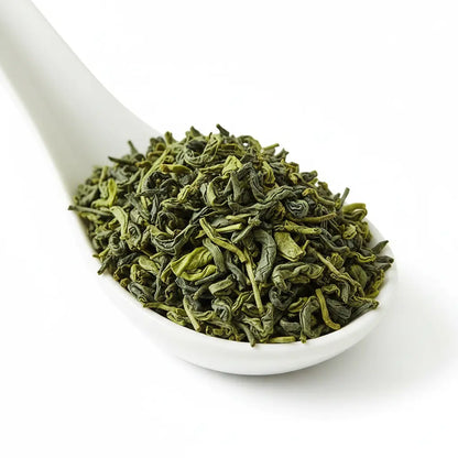 Pamir Green Tea 400g flat lay with tea leaves and brewed cup – Afghan green chai oriental supermarket Prague