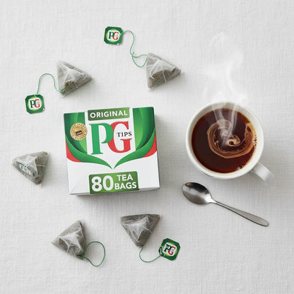 PG Tips Original 80 Tea Bags flat lay with mug of black tea and milk – British tea oriental supermarket Prague